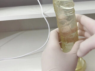 I give a handjob to the dildo with oily hands in medical white gloves