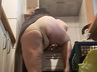 in the kitchen, relaxed, supported on her back