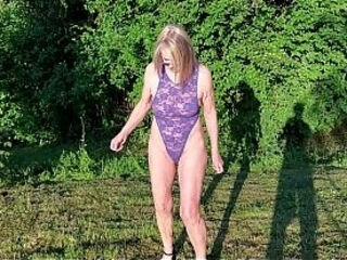 Granny is walking around her garden in a sheer bodysuit