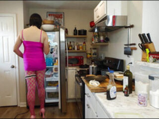Giant fake tits crossdresser in pink dress making breakfast